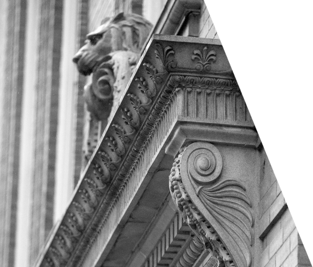 Decorative architectural elements of Vendi’s office exterior, including stone lion’s head and ornate exterior shelves