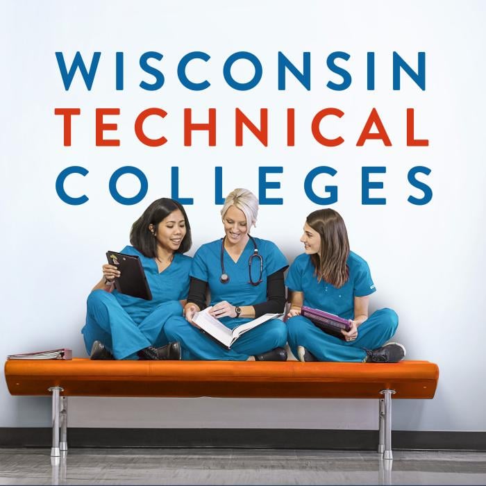 Wisconsin Technical Colleges three nursing students talking and laughing on an orange hallway bench