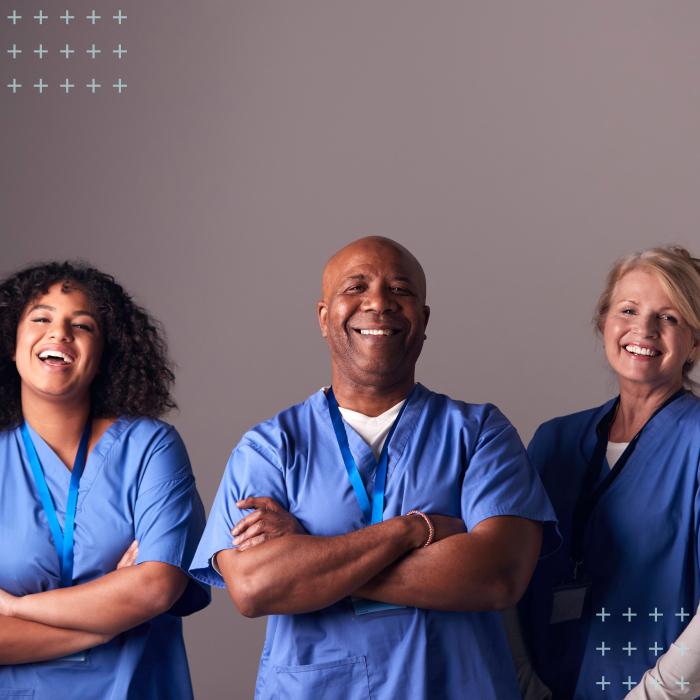 Two female and one male nurse anesthesiologist members of AANA wearing scrubs