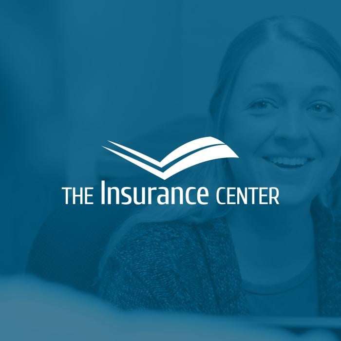 Employee of The Insurance Center underneath a blue photo overlay and centered, all-white version of The Insurance Center’s logo