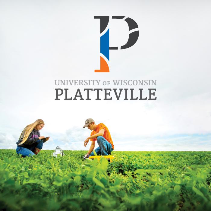 Two UW-Platteville students in a farm field, underneath the new P logo created by Vendi Advertising