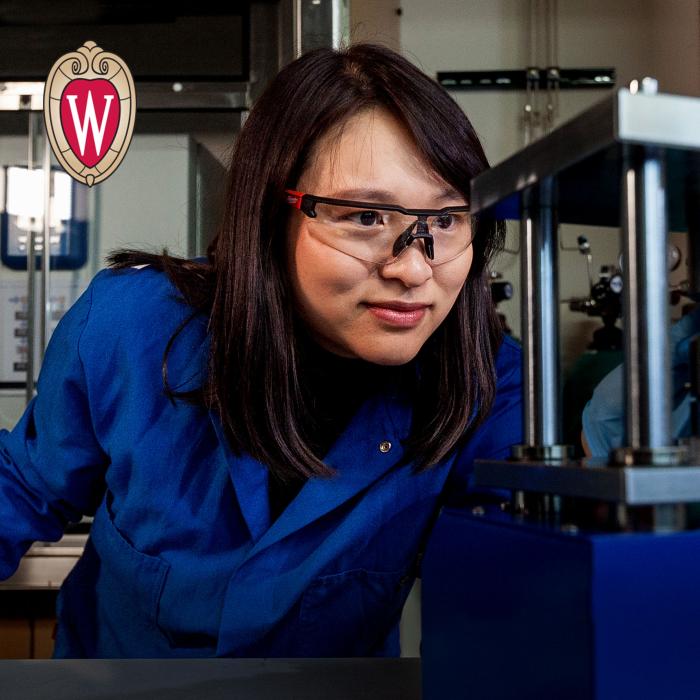 Young female student in the lab. UW Madison logo in the top left corner